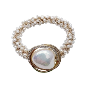 Elegant woven pearl hair tie with large iridescent baroque pearl and gold crystal trim