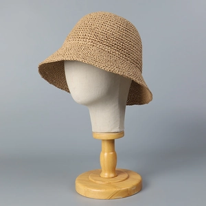 Handwoven khaki straw cloche hat for women featuring a minimalist bucket design for beach