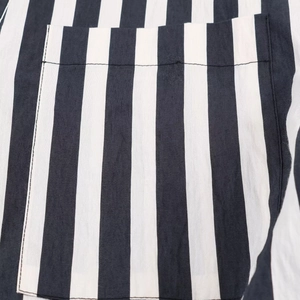Detail of pocket stitching and alignment on black and white striped casual shirt