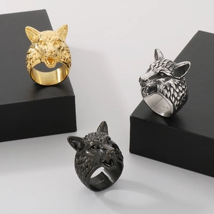 Three punk style stainless steel wolf head rings in gold, silver, and black finishes