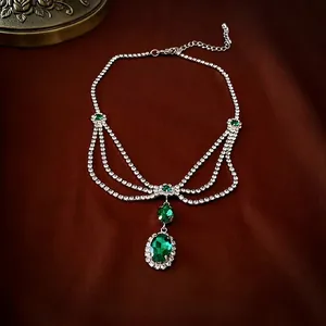 Luxurious emerald style rhinestone necklace with oval green gemstone and silver chain