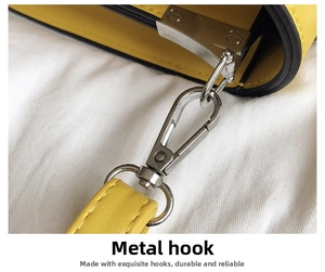 Macro detail of the durable silver lobster clasp hardware on a yellow PU leather handbag