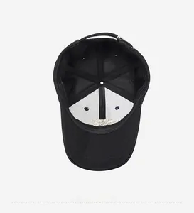 Detail view of the black baseball cap interior with white stiffener and adjustable metal buckle