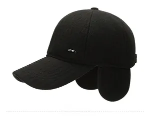 Detail of silver feather metal ornament on black wool baseball cap for men