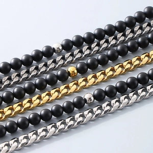Close-up of matte black agate beads with silver and gold cuban chain link details