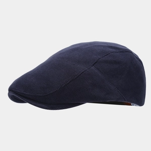 Detailed side profile of navy blue knitted flat cap showing texture and sleek ivy style