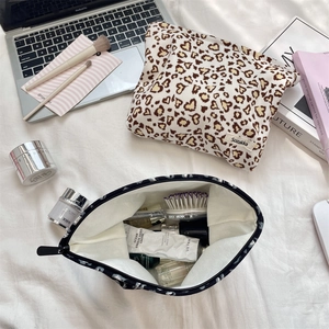 Detail of corduroy leopard print makeup bag showing large capacity for skincare and brushes