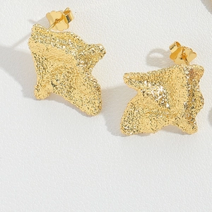Detail of gold square earrings featuring a unique wrinkled metal texture on white background