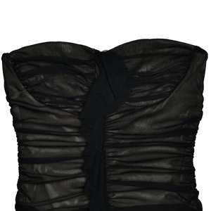 Detail of black sheer mesh tube dress featuring ruched texture and vertical ribbon trim