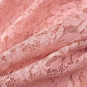 Detailed view of pink lace fabric texture for sexy short polo shirt for women