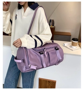 Close-up of purple large capacity travel bag with nylon texture and adjustable shoulder strap