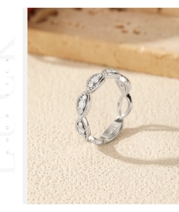 Detail of S925 sterling silver braided ring with pavé moissanite stones and vintage texture