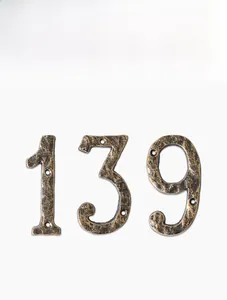 Detail view of rustic cast iron numbers 1, 3, and 9 with vintage hammered texture