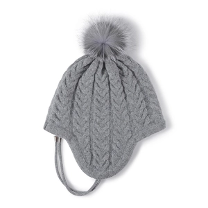 Grey cable knit winter hat with large faux fur pompom and earflaps for women