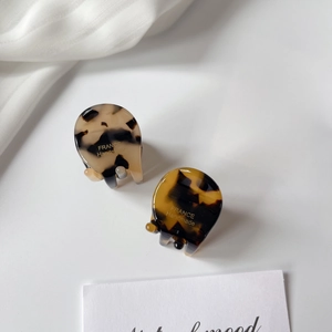 Close-up of mini tortoise shell acetate hair clips with France Handmade gold lettering