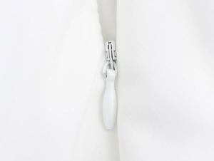 Detail shot of the high-quality hidden white zipper on a tropical maxi dress