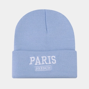 Macro detail of Paris French embroidery on a light blue knitted beanie hat fold
