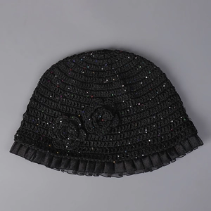 Detail of crochet bucket hat with floral accents, colorful sequins and mesh trim