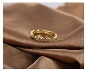 Close-up of gold plated brass ring with full circle of round brilliant-cut cubic zirconia