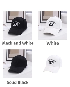 Detailed grid view of cotton baseball caps in black and white with 23 embroidery