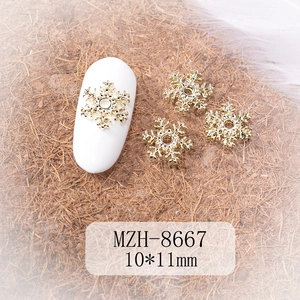 Macro shot of gold snowflake nail art charm with dimensions of 10x11mm for DIY manicure