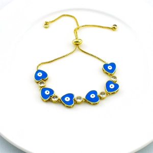 Gold evil eye bracelet featuring blue enamel hearts and clear cubic zirconia stones