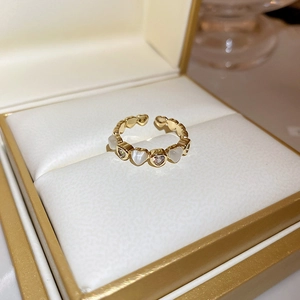 Close-up of cat-eye and pearl heart-shaped ring displayed in a premium jewelry box