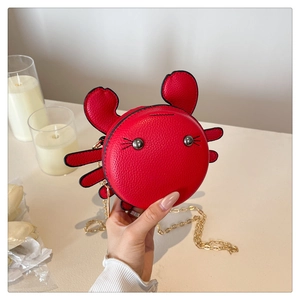 Litchi texture red crab-shaped mini bag with golden chain strap held by hand