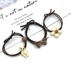 Brown and beige elastic scrunchies set with bear, flower, and bow charms for women