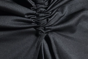 Detail of black elastic milk silk fabric with professional ruched stitching and texture