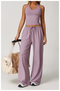 Detail view of high-waist drawstring wide-leg pants and matching halter top in lilac