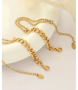 Detail of 18k gold plated stainless steel curb and bead chain bracelet with K18 tag