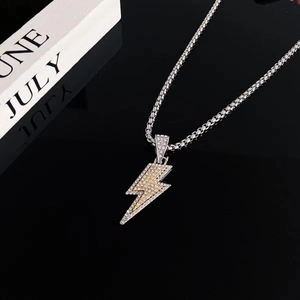 Sparkling iced out lightning bolt pendant necklace with silver box chain for streetwear style
