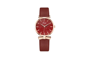 Detail of red leaf texture dial with rose gold case and burgundy leather strap