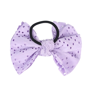 Lavender hollow eyelet fabric bow hair tie with black elastic band on white background