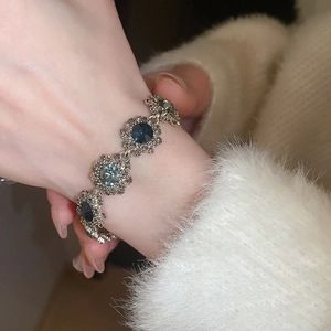 Close-up of vintage flower bracelet with deep blue crystals on a model's wrist