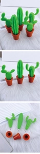 Detailed view of three creative cactus shaped pens in orange flowerpot stands