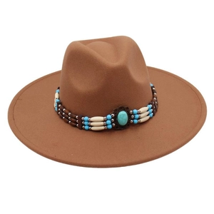 Close-up of brown wool fedora with ethnic beaded band and turquoise stone accent