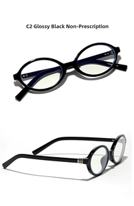 Detail of oval vintage glasses in glossy black featuring gold triple-bar hinge accents
