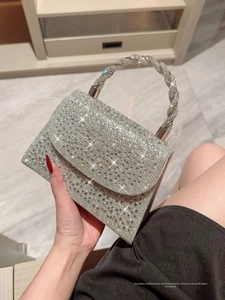 Detailed macro of silver evening bag with sparkling rhinestones and twisted handle
