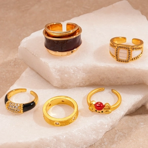Vintage gold geometric open rings set with diamond accents and brushed metal texture