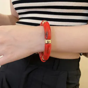 Minimalist iridescent acrylic geometric round bracelet with red resin and gold metal accents