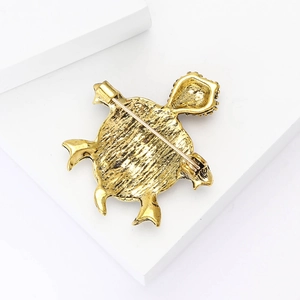 Detail view of the vintage gold turtle brooch back showing pin clasp and metal texture