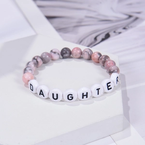 Detailed view of 8mm pink zebra jasper stone bead bracelet with Daughter letter beads