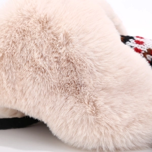 Detail of plush faux fur texture and ethnic knit pattern on a warm winter trapper hat