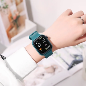 Dark green LED digital sports watch with rainbow square screen worn on a wrist
