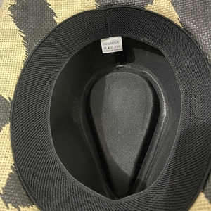 Detailed macro shot of the 100% paper material label and black inner lining of the hat