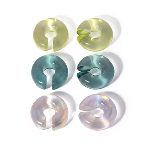 Minimalist resin C-shape ear clips in pastel green, cyan, and iridescent pink colors
