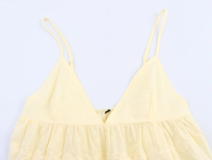 Detailed embroidery on a yellow cotton camisole top with thin straps and V-neckline