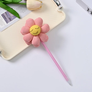 Close-up of pink smiley flower ballpoint pen made of corduroy fabric on a stylish tray